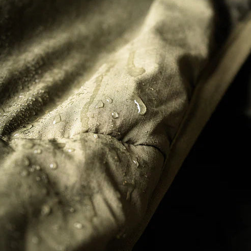 Close-up view of the fabric on the Eberlestock Alturas Hooded Jacket repelling water.