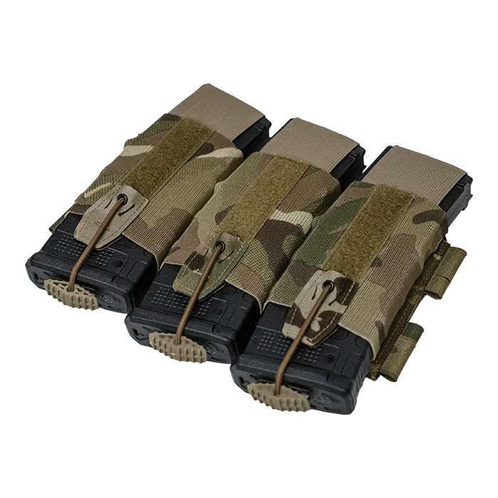 A detailed close-up of the MultiCam magazine pouch, highlighting the rigid re-indexing tab and the secure Shock cord routed through a metal eyelet to firmly hold a black rifle magazine in place.