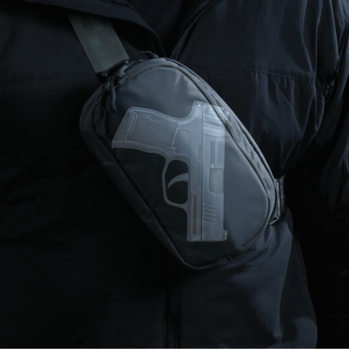 an image of the eberlestock fade flex micro in the color black and showcases how a gun would fit into the sling pack
