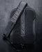 Close-up of the Eberlestock Fade Sling XL's padded mesh back panel and shoulder strap, showing the breathable material and adjustable strap hardware.