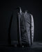 Side profile of the Eberlestock Fade Sling XL in black, showing the slim pack depth, top zipper pull, and adjustable sling strap with cam buckle.