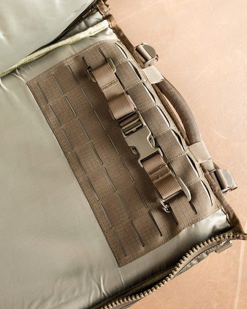 A close-up shot of the interior of the Eberlestock Spectre Backpack showing the specialized RAID scabbard with MOLLE webbing and heavy-duty adjustable straps designed to secure a precision rifle.