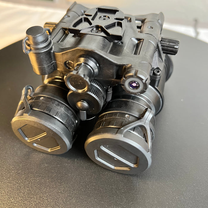 A top frontal view of the elbit f5032 night vision system highlights the manual gain control knob used to fine-tune image brightness, with the integrated IR illuminator positioned in the foreground for visibility in absolute darkness.