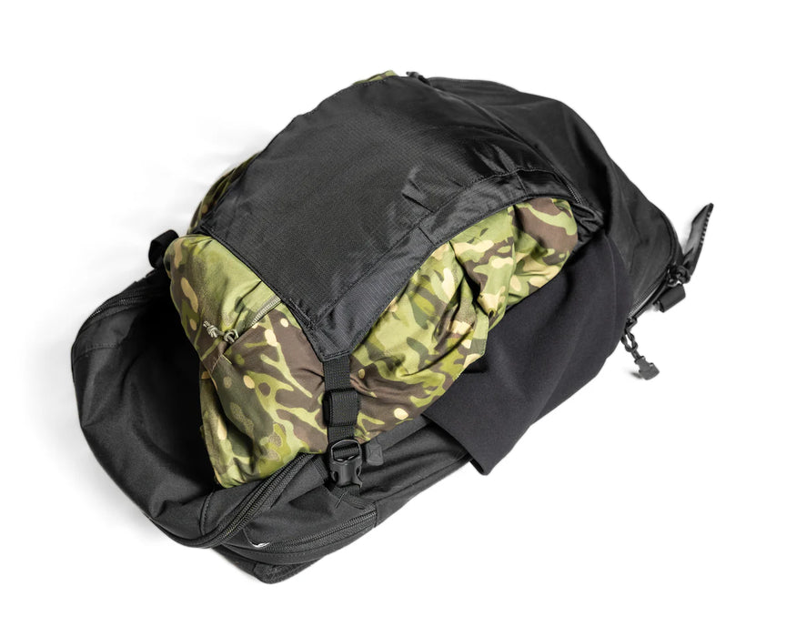 The expanded front panel of the Gamut 22L Sling Bag, featuring a stowable gear sling designed to carry bulky or dirty items like helmets outside the main compartment.
