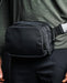 an image of the eberlestock fade flex micro in the color black and is being worn by a product modeler on his waist.