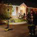 Firefighters using the Streamlight Portable Scene Light to illuminate the front of a house during night operations