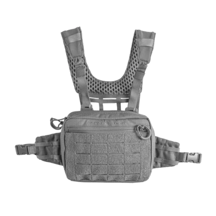 A front-facing view of an gray tactical chest pack laying flat, featuring a breathable mesh harness and a front zippered pocket with laser-cut mounting points.