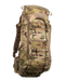 A frontal angled view of the Eberlestock Brute 3500 Multi-Day Hunting Pack in Multicam, showing how the specialized camo pattern blends into the environment while highlighting the rugged storage compartments.