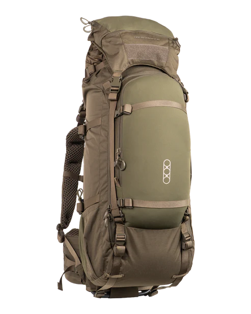 A frontal angled view shows the Eberlestock Brute 6500 Hunting Pack in Military Green, featuring its expandable roll-top and the contoured harness system designed for heavy hauling.