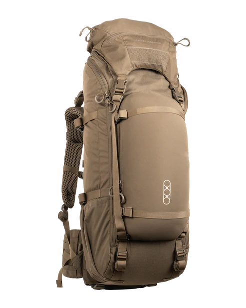 A frontal angled view of the Brute 4500 Load Hauling Pack in Dry Earth tan, showcasing the reinforced stitching and the heavy-duty adjustable hip belt designed to manage extreme weight during backcountry extractions.