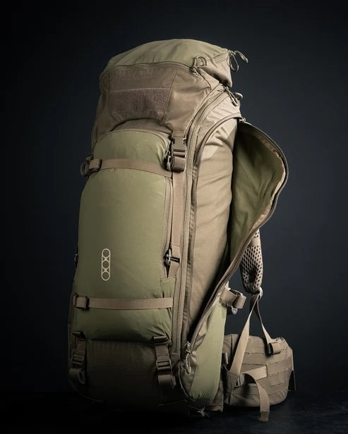 A frontal right view of the Eberlestock Brute 4500 Tactical Pack in military green, featuring one of the specialized side pockets opened to reveal the protective internal storage space for high-end spotting scopes.