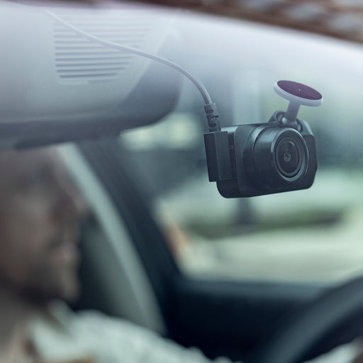 garmin-dash-cam-mini-3-mounted-to-windshield-with-driver-in-background-gallery