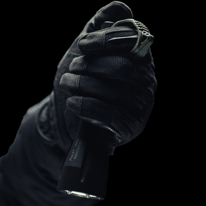 gloved hand firmly holding flashlight with installed olive drab switchback hog