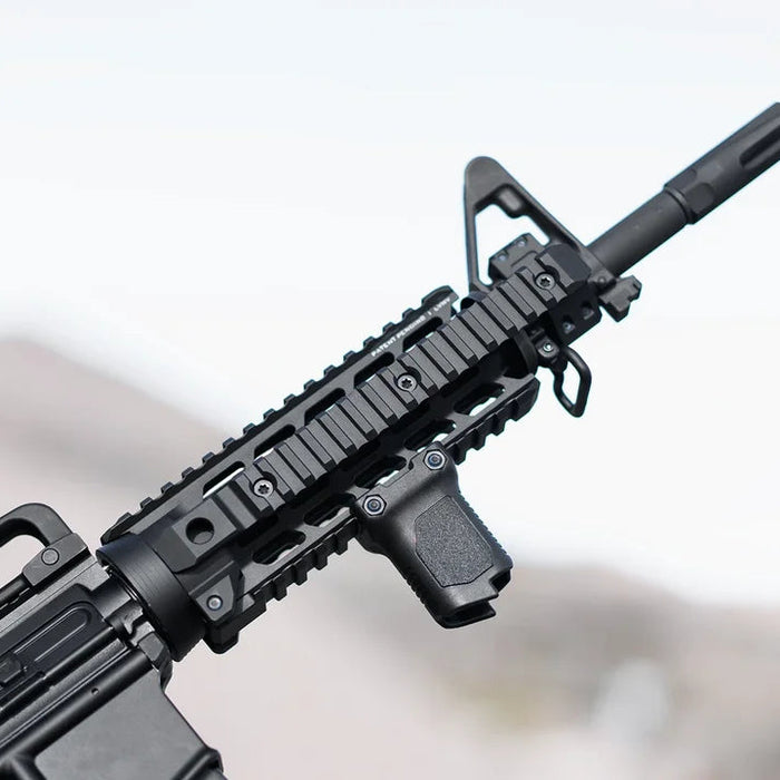 A side profile of a customized rifle featuring a secondary handgun attached to the lower section of the Strike M4 Hand guard, showing a vertical grip securely mounted to the bottom Picatinny rail for improved stability.