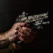 holding-handgun-with-camo-finish-equipped-with-surefire-x400vh-masterfire