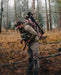 A hunter pausing to adjust the Cradle Hip Belt on his F1 Mainframe II, ensuring the weight of a fresh harvest is perfectly balanced and transferred to his hips for the extraction.