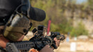 A marksman is shown practicing at a shooting range with a tactical rifle setup that features the Infitac Fast Mini FML19 , utilizing the unit’s high-sensitivity thermal sensor to identify targets through heat signatures during live-fire drills.