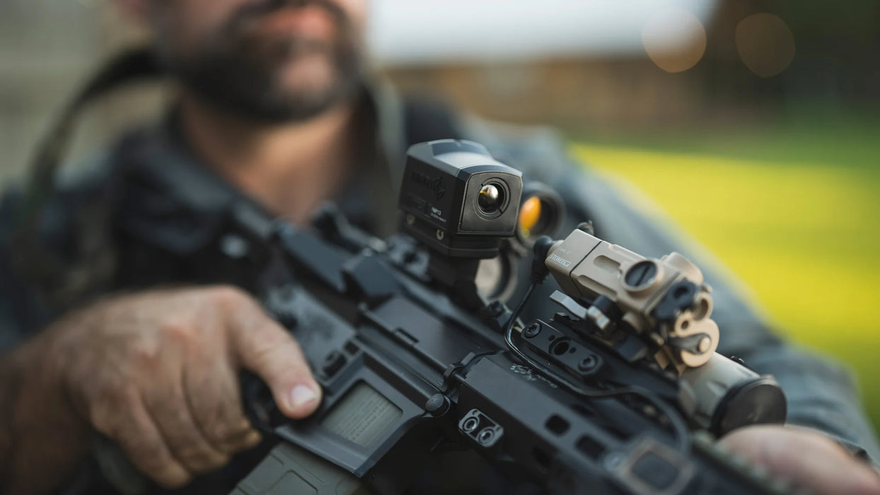 The InfiTac FML19 2x19mm Thermal Imaging Rifle Scope is securely mounted as a secondary offset sight on an AR10 rifle , demonstrating how the compact unit provides quick thermal target identification alongside a primary magnified optic.