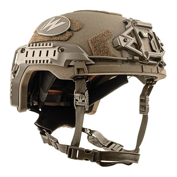 A precise left-angled isometric view of the Team Wendy RifleTech helmet in Coyote Brown, highlighting the durable matte finish and the tactical rail interface system for mounting lights and headsets.