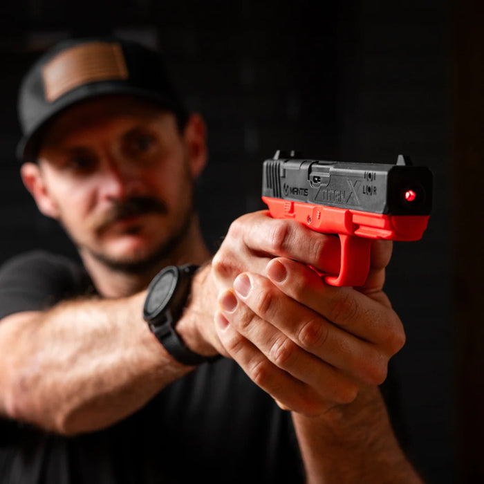 Shooter practicing dry fire techniques safely at home using the Mantis TitanX smart laser training pistol
