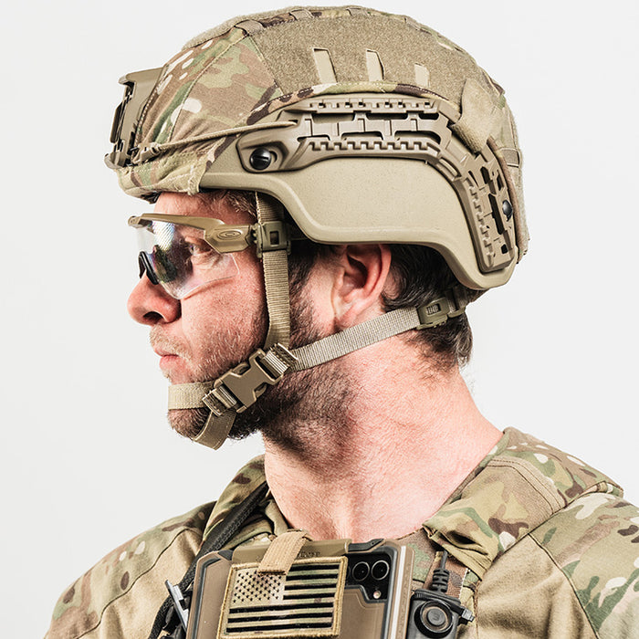 member of armed forces wearing tan mid/full cut hellbender te helmet with multicam cover