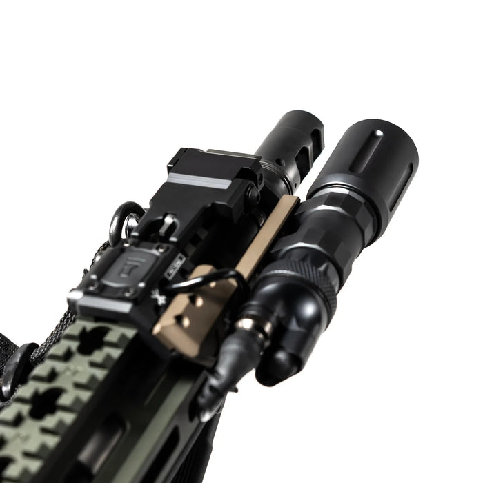 An image of the modlite-plhv3 18350 rifle light in the color black with the rifle attchments placed on its body and is being attached to a black rifle using a light mount that is in the color brown and has a metallic finish.