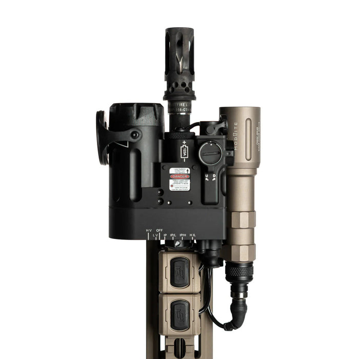 An image of the modlite plhv3 18350 rifle light package in the color FDE where the product itself is attatched to a rifle and is plugged in and ready to use, where the rifle also seems to be  having other attatchments that are in the color blacka and FDE