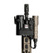 An image of the modlite plhv3 18350 rifle light package in the color FDE where the product itself is attatched to a rifle and is plugged in and ready to use, where the rifle also seems to be  having other attatchments that are in the color blacka and FDE