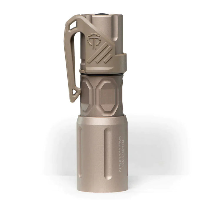 An image of the modlite multi-mode handheld plhv3 18350 flashlight showcasing the item in the color FDE placed in the middle of the photo and with a textured grip and white product lettering detailing its dual fuel, multi-mode capabilities on a reflective surface and with the thyrm low profile clip attached to it.