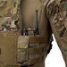 A close-up view of an operator wearing a tactical vest featuring the MultiCam LPV Side Radio Pouch mounted on the side straps. The pouch securely holds a black communication radio, demonstrating its versatile design that can accommodate a radio or M4 mag.