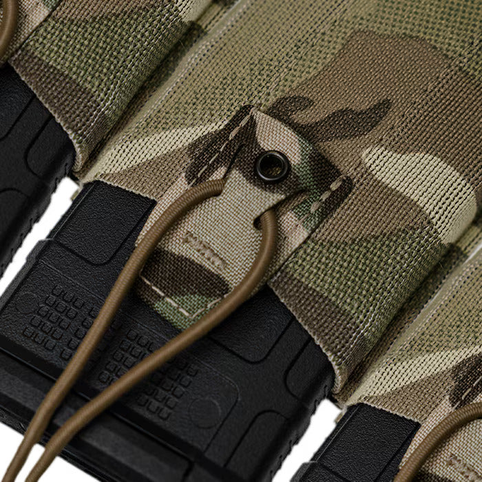 A detailed close-up of the MultiCam magazine pouch designed for low-profile carriage, showcasing the optional passthroughs built into the fabric tab that allow operators to route a double shock cord for customizable magazine retention.