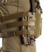 A close-up side view of an operator wearing a tactical vest demonstrating the crye precision low-profile visibility setup. The MultiCam Side Radio Pouch is mounted on the side straps and configured in an inverted orientation, securely holding a brown rifle magazine downwards using the shock cord retention system.