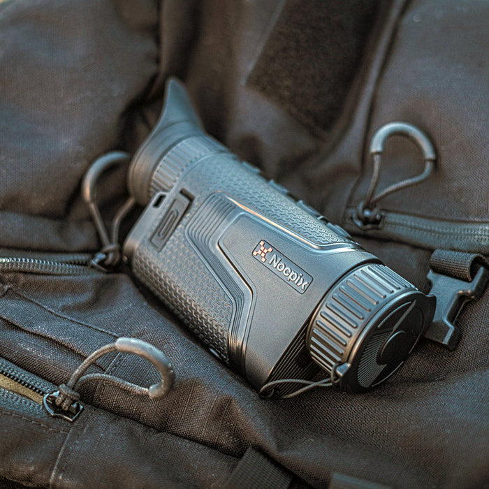 nocpix lumi l35 rests on top of a black backpack
