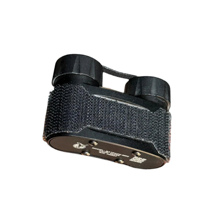 a product image of the nocturn industries in the color blacki and showcased a tilted back view where you can get a view of the bottom part of the item that is in a shade of brown and has for screws, the product bodu that looks like it has a velcro-like attachment around it, and also the two cylindrical caps on the top that is where the two AA batteries or CR123A batteries are inserted.