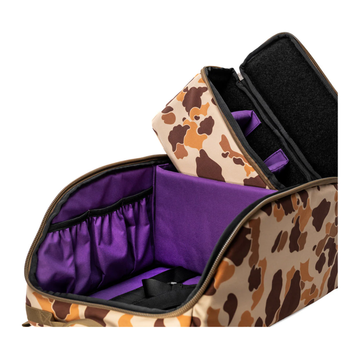 An open tactical storage bag featuring a vintage duck camouflage exterior and a striking purple padded interior, showcasing premium ottegear design elements with its matching rectangular accessory pouch resting comfortably inside the main compartment.