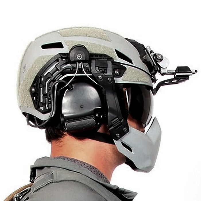 person is shown from the side wearing a kitted-out tactical helmet with a galvion caiman nvg arm visor against a white background