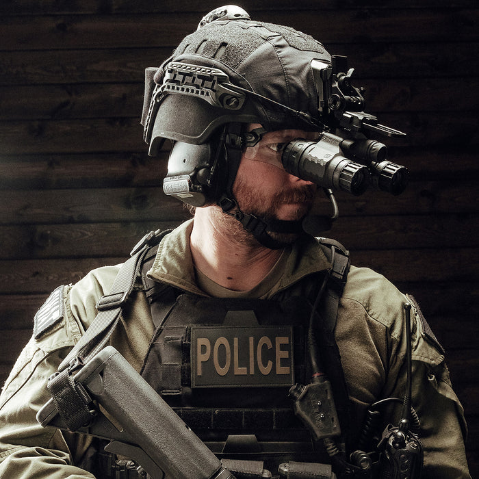 police officer wearing black mid/full cut hellbender te helmet with mounted nvg