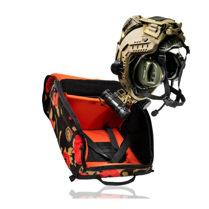 An open poppy flower camouflage gear bag with an orange interior and a fully equipped tan helmet floating above it, perfectly demonstrating how big can fit in V2 OG Tactical Helmet Bag w/ Nods Box including mounted night vision and communication headsets.