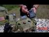 A YouTube video thumbnail showing a tactical gear expert holding the black programming module during a comprehensive HEL-STAR 6 GEN III+ & HEL-STAR F2 Review, demonstrating how to wirelessly sync the helmet beacons.