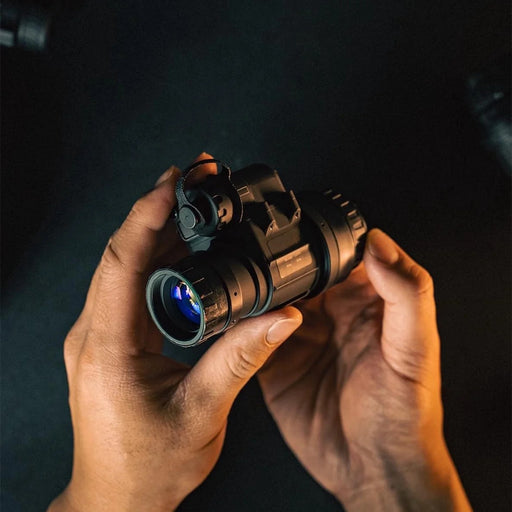 our product manager holds the lightweight RVM-14 at a side angle, showing the rugged battery compartment and front lens of this high-performance pvs 14 nvg system.