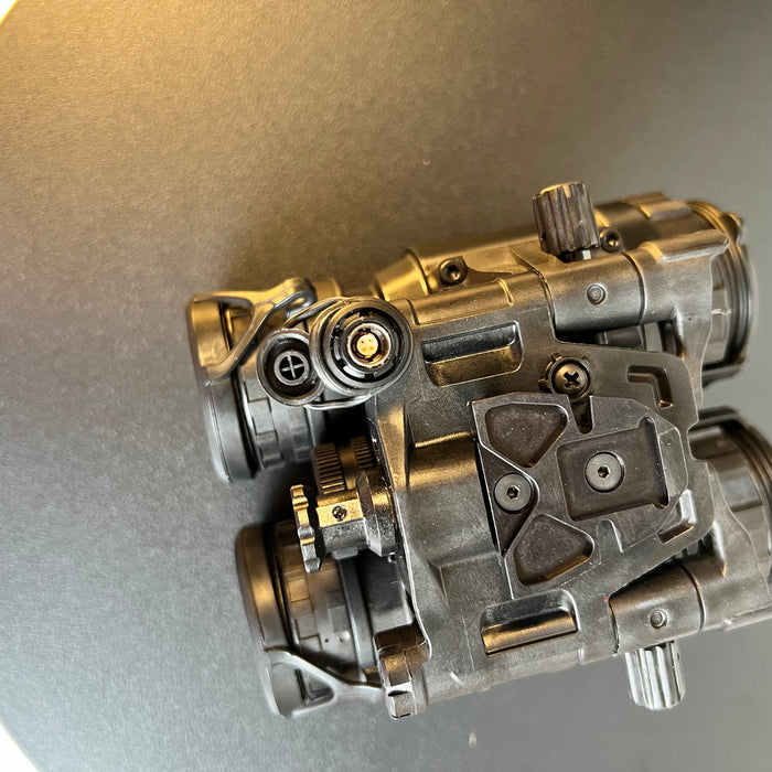 A top-down close-up shot focuses on the external power port and the secure dovetail mount of the pvs 31 night vision system, highlighting the robust interface designed for helmet attachment and extended operation via an external battery pack.