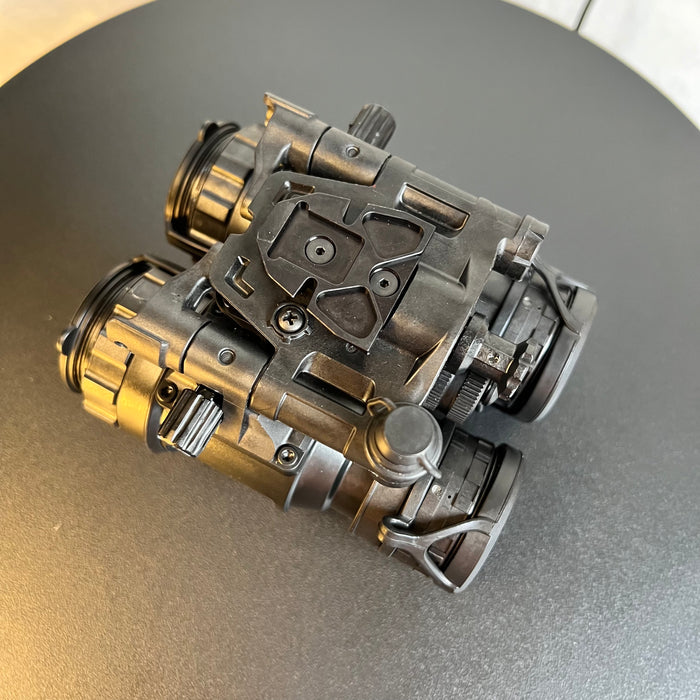  A top-side view of the night vision goggles highlights the rugged articulating housing and the compact profile of the pvs 31d, showing the lightweight design intended to solve the problem of neck fatigue during long missions.