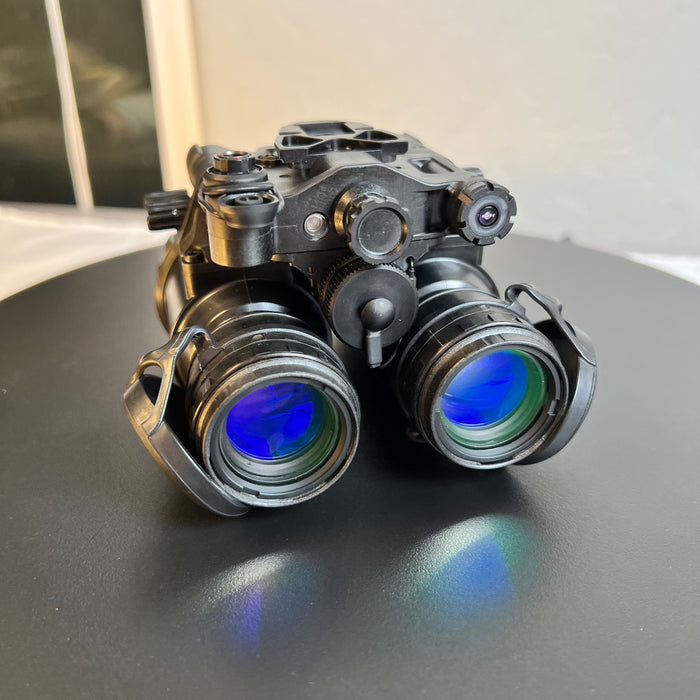 A clear frontal view of the pvs31d night vision binocular highlighting the Gen 3 white phosphor thin-filmed objective lenses and the integrated infrared illuminator used for visibility in absolute darkness.