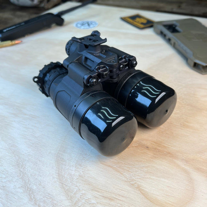 Captured from a rear right-hand angle, this uanvb katana reveals the ocular lens side of the binocular system, with the objective lenses at the far end safely covered by protective rubber caps.