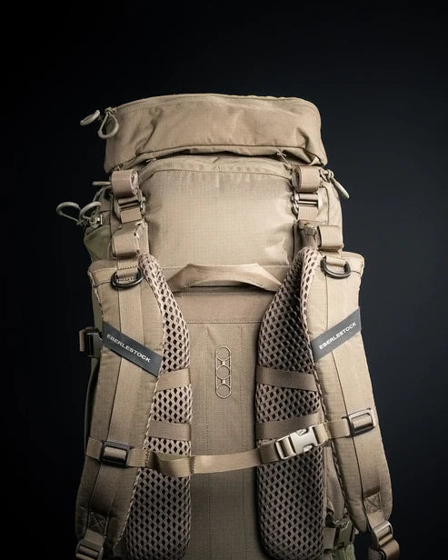 A detailed rear shot of the Eberlestock Brute 4500 Hiking Backpack, showcasing the breathable airflow padding on the contour shoulder straps and the adjustable sternum strap for maximum stability.