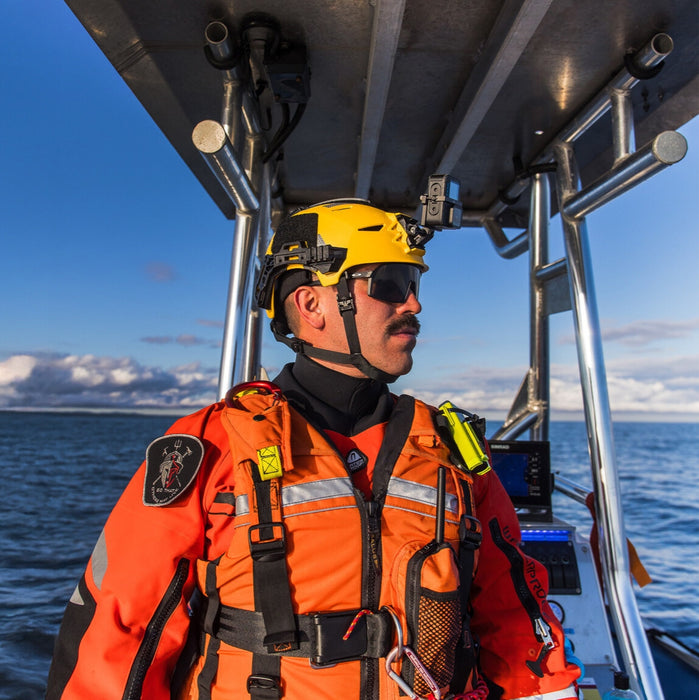 Rescuer wearing a yellow Team Wendy EXFIL Rescuer helmet patrolling the coast.