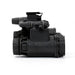 Right side profile of the binocular night vision device, showing the cylindrical optical housing, adjustment controls, and folding bridge mechanism mounted above the optic body.