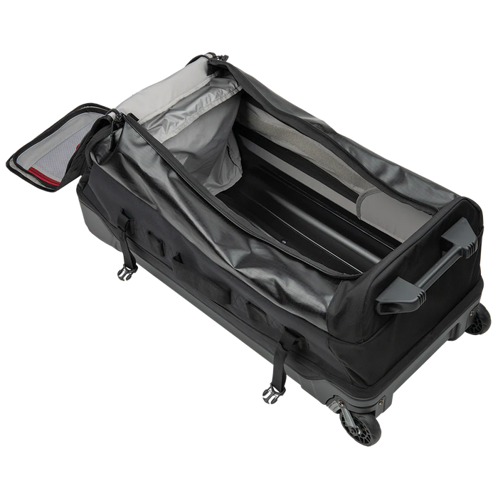 Captured from a high-angle side perspective, the RLT 100L is shown with its wide main compartment fully unzipped, showcasing the massive internal storage space and the light-colored lining that makes finding gear easy.