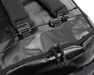 A close-up shot focusing on the side of the RLT 80L Duffel Bag shows the expandable side pouch, high-quality locking YKK zippers for secure closure, and the durable Duraflex Quick-Release buckle in the foreground used for the backpack strap system.