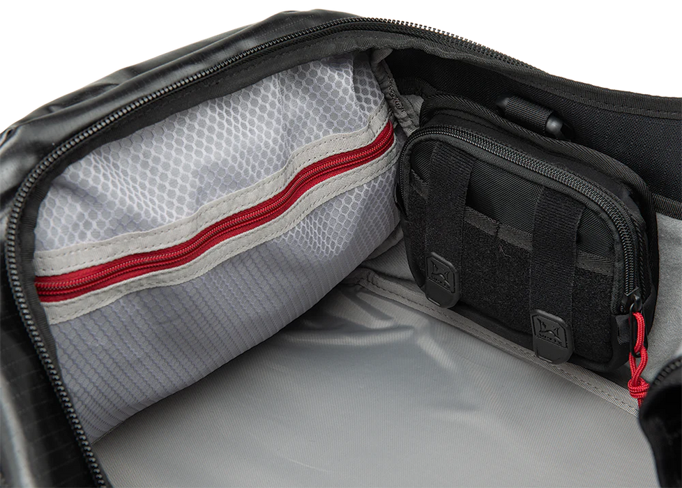 This detailed close-up shot of the RLT 80L Duffel Bag features the main compartment fully opened, showcasing how various hook-backed Tactigami accessories and organizers attach securely to the internal loop lining for a customized gear layout.